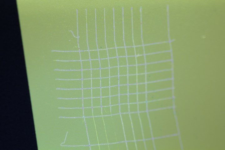 Cross-hatch lattice scored through yellow UV ink on N-Bond primed glass with no flaking between the cuts