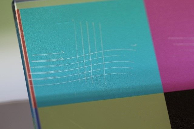 Cross-cut adhesion test on UV inkjet printed glass primed with N-Bond, showing no flaking along the scored lattice